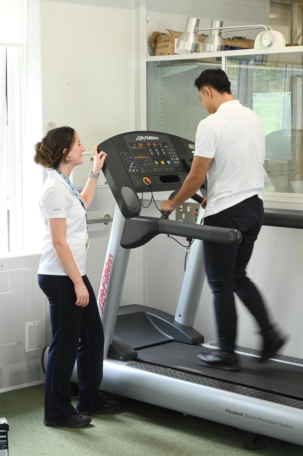Clinician with patient on treadmill